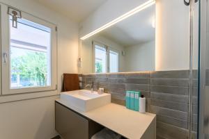 a bathroom with a sink and a mirror at Residence Da Marco in Pieve di Soligo +142 photos