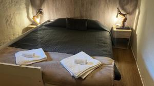 a bedroom with a bed with towels on it at Vale Das 7Lagoas in Geres +79 photos