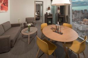 a living room with two tables and a couch at The Level at Meliá Barcelona Sky in Barcelona