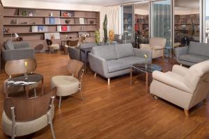 a living room with couches and chairs and tables at The Level at Meliá Barcelona Sky in Barcelona +76 photos