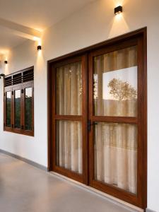 two large doors in a room with windows at The Don Dock Kandy in Kandy +2 photos