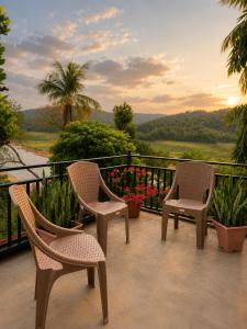 two chairs sitting on a balcony with a view at The Don Dock Kandy in Kandy