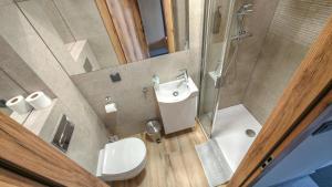 a bathroom with a toilet and a sink and a shower at Rest&Drive in Warszowice +33 photos