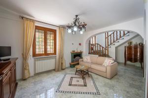a living room with a couch and a staircase at Il Vigneto in Tramonti