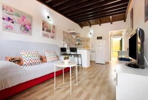 a living room with a couch and a table at Casa Yoaki in Corralejo +14 photos