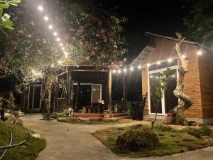 a house with lights on it at night at Bee House in Long Thủy