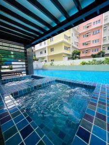 a swimming pool with blue tiles in a building at Oasis 8 in Bacolod