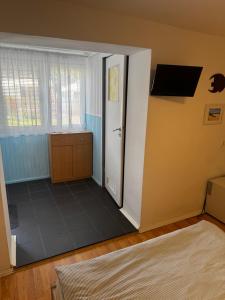 a room with a door and a window and a floor at U Jaśka in Darłowo