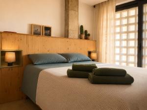a bedroom with a bed with two pillows on it at Viviendas El Tiburón in Almerimar