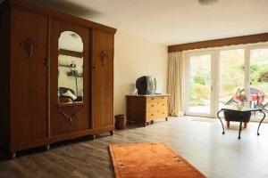 a living room with a dresser and a mirror at Feriendomizil Bockelmann in Bad Bevensen