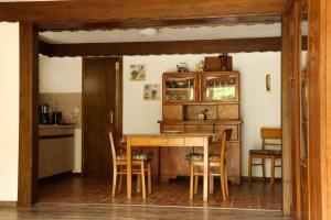 a kitchen with a wooden table and chairs at Feriendomizil Bockelmann in Bad Bevensen