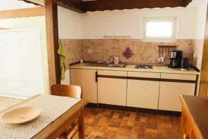 a small kitchen with a sink and a table at Feriendomizil Bockelmann in Bad Bevensen +10 photos