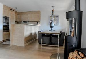 a kitchen with a table and a kitchen with a refrigerator at Luxury Grimentz Apartment in Grimentz