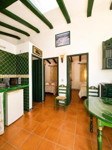 a kitchen with a table and chairs in a room at Villas El Cañuelo in Monturque