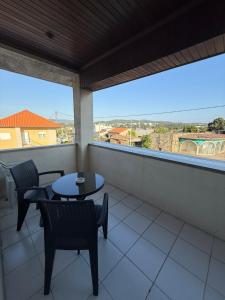 a balcony with tables and chairs and a view at Barcelos Residence Living in Barcelos