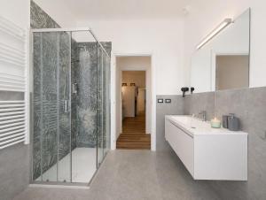 a bathroom with a shower and a white sink at Konero Room in Loreto