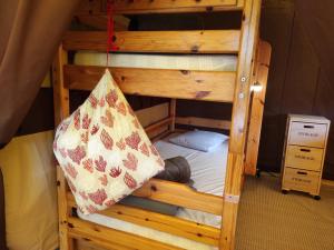 a person laying on the bottom bunk of a bunk bed at clos du loguy in Pénestin