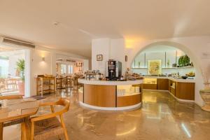 a large kitchen with an island in the middle of a room at Hotel Cala Dor - Adults Only in Cala d´Or