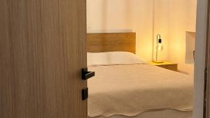 a door leading into a bedroom with a bed at Meliti Home in Therma