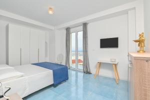 a hotel room with a bed and a television at Agropoli Palace in Agropoli