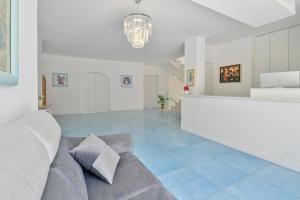 a living room with a couch and a chandelier at Agropoli Palace in Agropoli