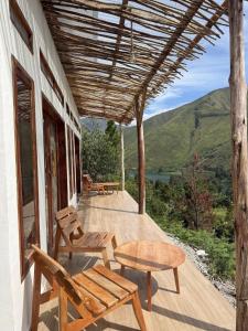 a porch of a house with a table and chairs at Slash Villa in Silimapuluh +4 photos