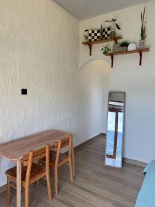 a dining room with a table and a mirror at Slash Villa in Silimapuluh