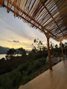 a wooden deck with a view of the water at Slash Villa in Silimapuluh