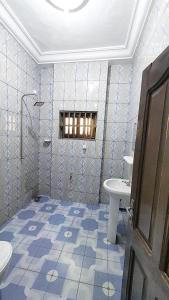 a bathroom with a toilet and a sink at Home Appart in Porto-Novo