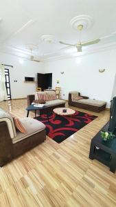 a living room with two couches and a tv at Home Appart in Porto-Novo