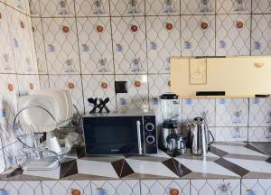 a kitchen with a counter top with a microwave at Home Appart in Porto-Novo