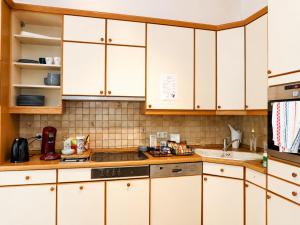 a kitchen with white cabinets and a sink at rooms lux city in Luxembourg +22 photos
