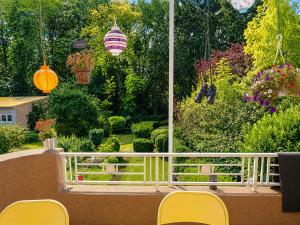 a balcony with chairs and a view of a garden at rooms lux city in Luxembourg