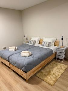 a large bed with two pillows on it in a room at Barcelos Residence Living in Barcelos +13 photos