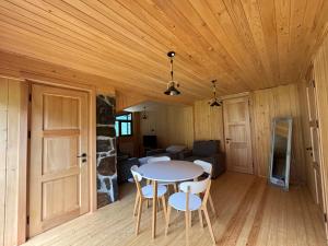 a dining room with a table and chairs in a room at Guesthouse Laurbili in Mestia +22 photos