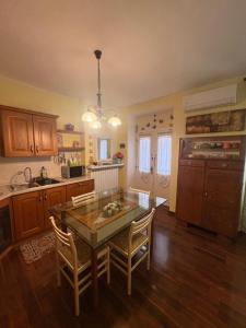 a kitchen with a table and chairs in a room at B&b Carducci in Gorizia