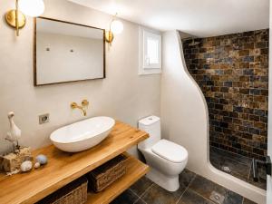 a bathroom with a sink and a toilet and a mirror at Navis Luxury in Skala Kallirachis