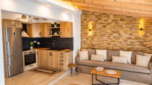 a living room with a couch and a kitchen at Navis Luxury in Skala Kallirachis