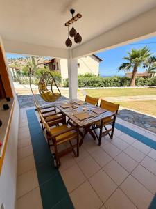 a dining room with a table and chairs on a patio at Villa Lemonia in Malia