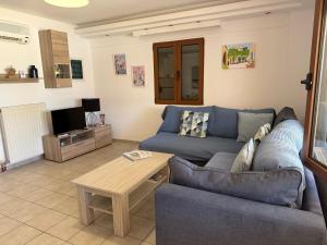 a living room with a blue couch and a table at Villa Lemonia in Malia