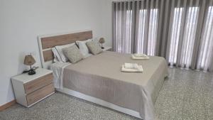 a bedroom with a large bed with two towels on it at Quinta de Basto House in Felgueiras +48 photos