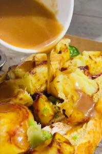 a plate of food with a sauce being drizzled at The Haughmond in Upton Magna