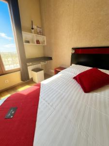 ein Schlafzimmer mit einem rot-weißen Bett und einem Fenster in der Unterkunft Marinha Hôtel in Gentilly + 38 Fotos