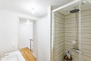 a shower with a glass door in a bathroom at Maison de Charme - Écrin de Nature in Saint-Privat +23 photos