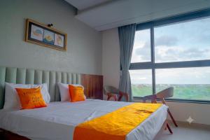 a bedroom with a bed and a large window at Hotel 5 Elements By Fidato Hotels in Akalkot