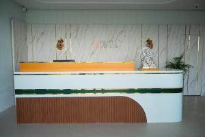 a reception desk in a room with a counter at Hotel 5 Elements By Fidato Hotels in Akalkot