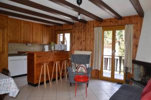 a kitchen with wooden cabinets and a table and chairs at Dent-Blanche in Les Collons +16 photos