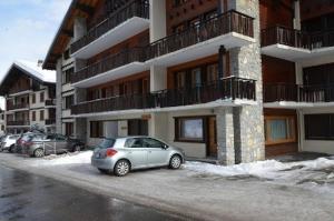 a car parked in a parking lot in front of a building at Dent-Blanche in Les Collons