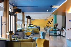 a lobby with couches and tables and chairs at Ilirija Resort Hotel Ilirija in Biograd na Moru