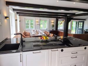 a kitchen with a sink and a counter top at FH Luhe-Hof - Historisches Reetdachanwesen in Winsen